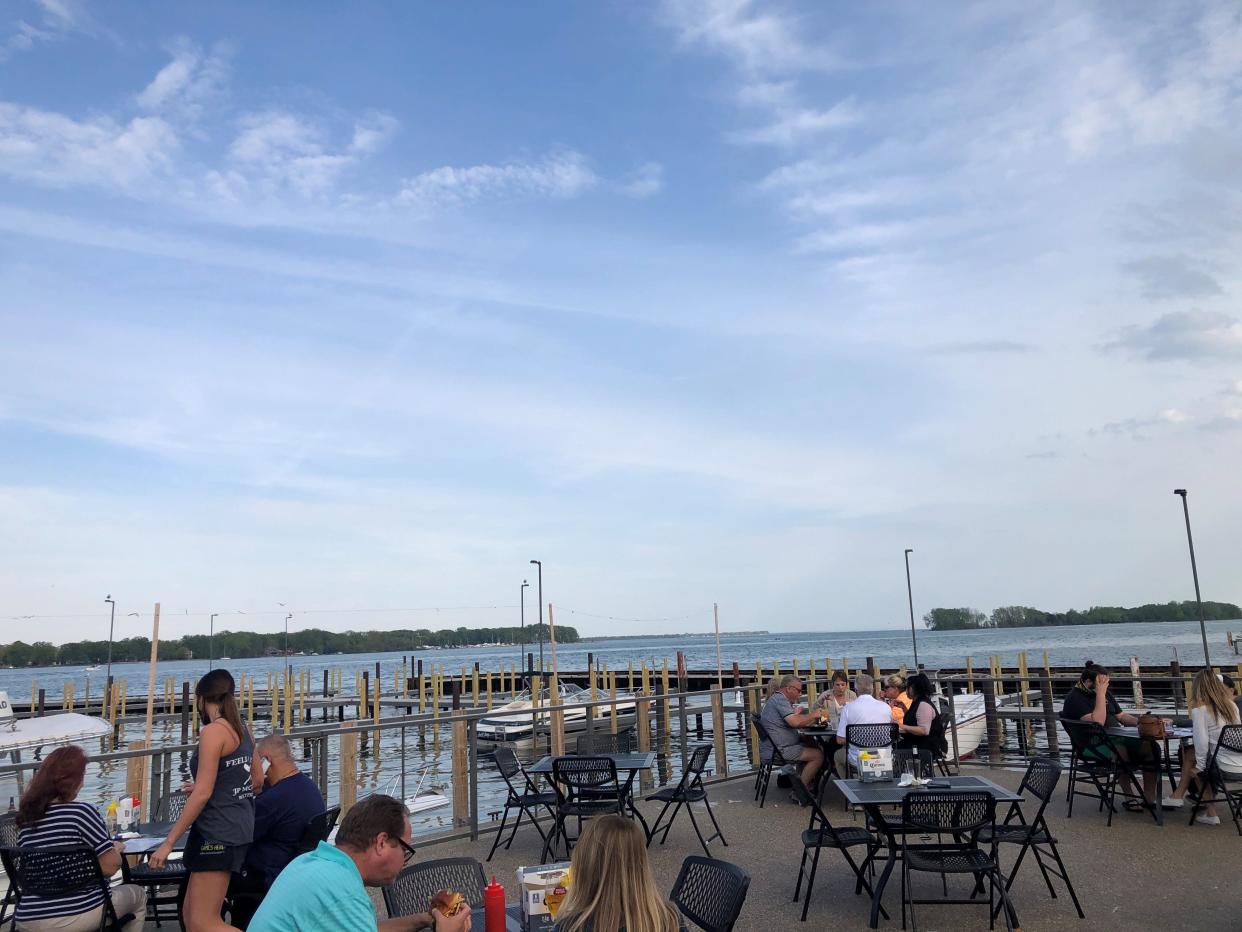 JP McGuire's Waterfront restaurant patio seating has views of Detroit River near the mouth of Lake Erie.