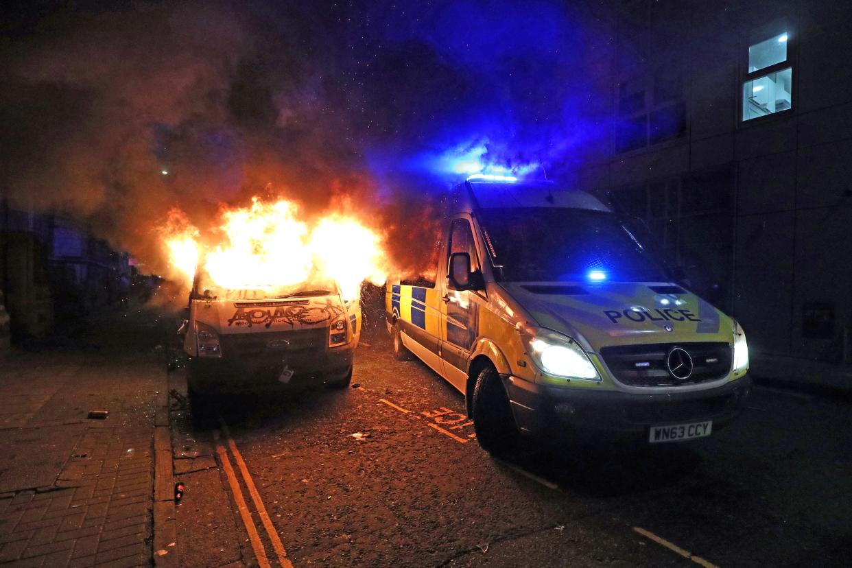 A vandalised police van on fire outside Bridewell Police Station (Andrew Matthews/PA) (PA Wire)