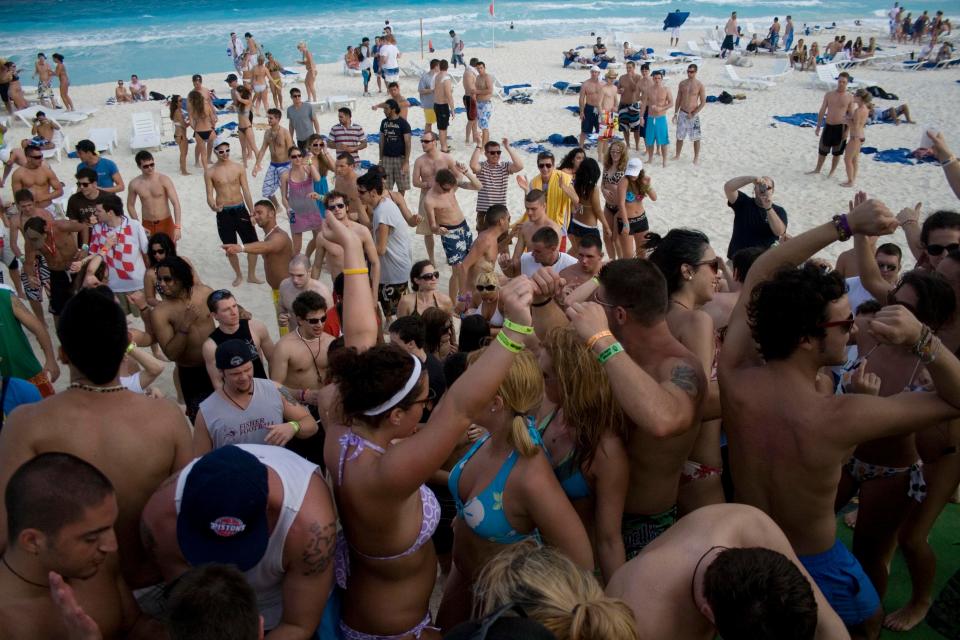 Spring breakers dance at the beach in the resort city of Cancun, Mexico, on March 1, 2010.