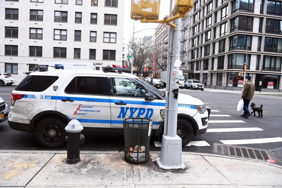 A NYPD police car is parked in front of a fire hydrant and in a crosswalk on Third Ave. and East 21st St. near the 13th Precinct station house. Helayne Seidman