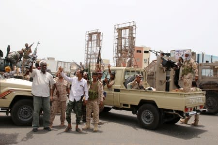 FILE PHOTO: Members of UAE-backed southern Yemeni separatist forces shout slogans as they patrol a road during clashes with government forces in Aden