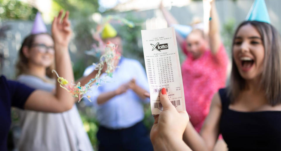 Photo of X Lotto ticket as two friends win $1.6 million each after they both bought tickets with the same numbers.