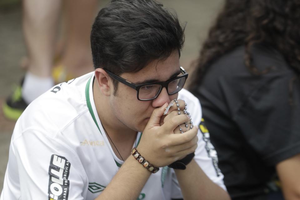 <p>A fan of Brazil’s soccer team Chapecoense mourns outside the Arena Conda stadium in Chapeco, Brazil, Tuesday, Nov. 29, 2016. A chartered plane that was carrying the Brazilian soccer team to the biggest match of its history crashed into a Colombian hillside and broke into pieces, Colombian officials said Tuesday. (AP Photo/Andre Penner) </p>