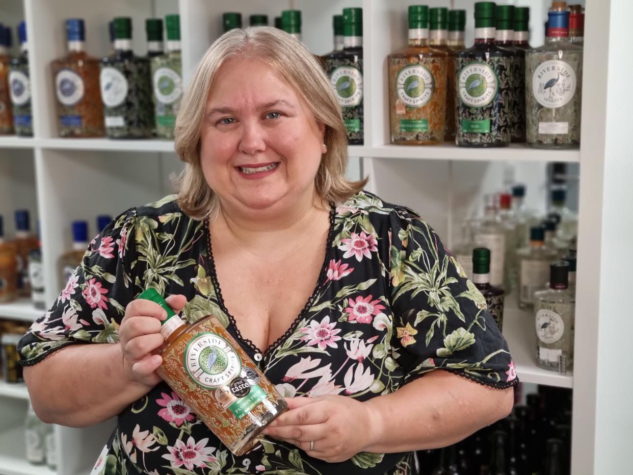 Woman holding a bottle of gin