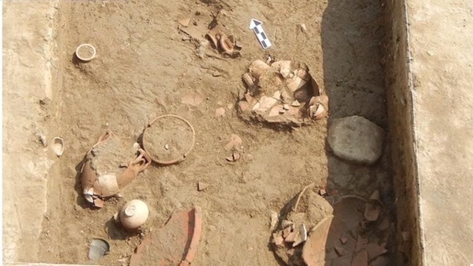 A bird's-eye view of the excavation site with pottery shards.