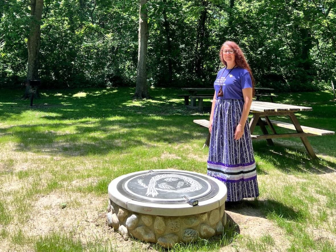 Caldwell Culture and Language Coordinator, Carrie Ann Peters, stands outside a fire pit that Point Pelee National Park has protected for ceremonial use by the Nation. (Josiah Sinanan/ CBC News - image credit)