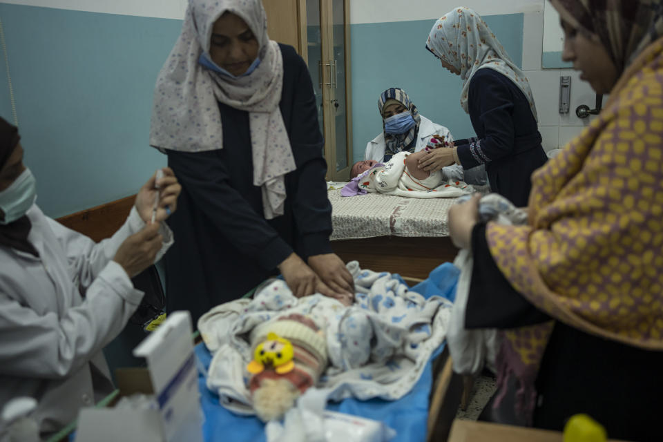 Palestinian children receive pentavalent vaccines in Rafah, Gaza Strip, Tuesday, Jan. 2, 2024. The vaccines, which protect against five diseases, recently entered Gaza in an international aid shipment and due to the ongoing war, most children are several months late for their immunizations. (AP Photo/Fatima Shbair)