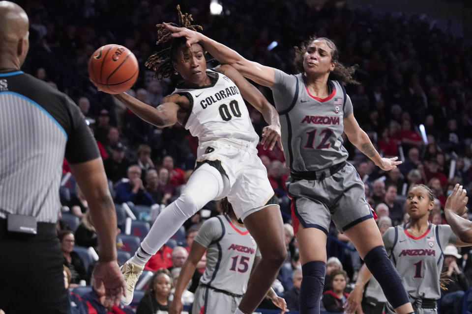 Colorado's Jaylyn Sherrod (00) is fouled by Arizona's Esmery Martinez (12) during the first half of an NCAA college basketball game Friday, Jan. 5, 2024, in Tucson, Ariz. (AP Photo/Darryl Webb)