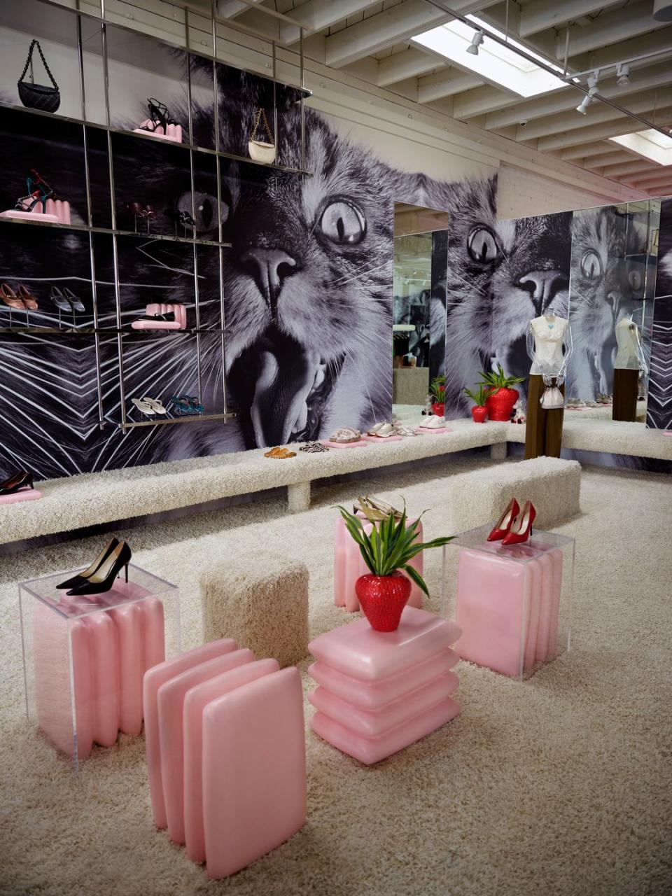 a store with a black cat statue