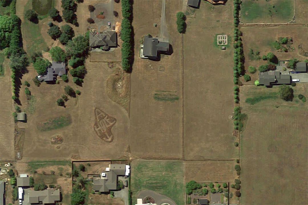 Google Map view of "A-Hole" written in the grass in a neighborhood