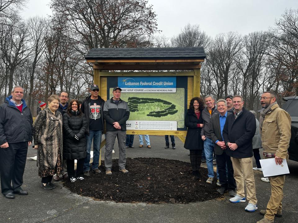 Members of the the Coleman Memorial Park board of trustees, elected officials, sponsors and the designers of the course officially opened the new disc golf course by removing sheets that covered its map.