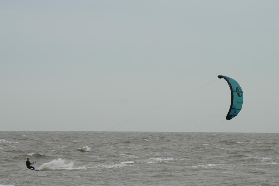 Wind surfers on the sea as they take advantage of strong winds near Clacton-on-Sea, England, Wednesday, Oct. 18, 2023. Storm Babet is due to cross the United Kingdom with yellow wind warnings from Wednesday to Saturday in place, an red rain warning has also been issued for parts of Scotland .(AP Photo/Frank Augstein)