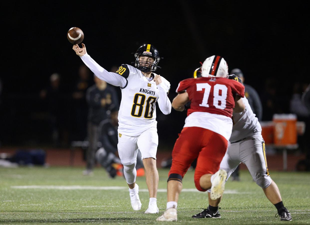 McQuaid quarterback Will DiMarco throws over Hilton’s Hunter Tracy.