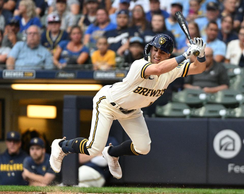 Brewers outfielder Sal Frelick grimaces after taking a pitch to the knee against the Rockies on Aug. 7.