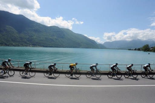 Yellow jersey leader Bradley Wiggins (C) rides, on during the sixth stage of the 64rd edition of the Dauphine Criterium cycling race between Saint-Aban-Leysse and Morzine, French Alps. He tightened his grip on the overall lead