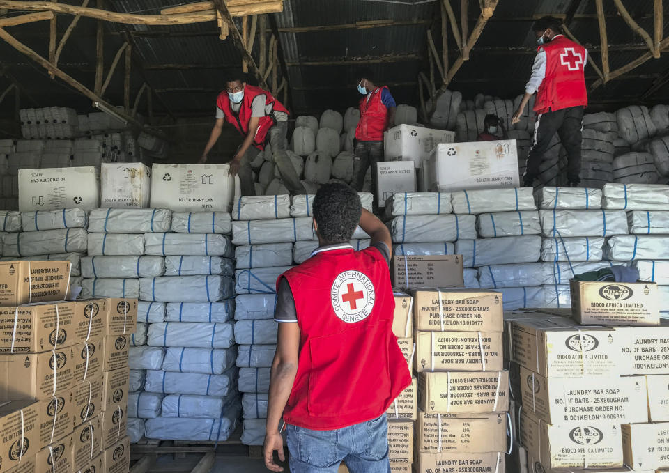 Ethiopian Red Cross Society (ERCS) and International Committee of the Red Cross (ICRC) volunteers prepare supplies for dispatch at a warehouse in Mekele, the regional capital of the Tigray region of northern Ethiopia Friday, Jan. 22, 2021. Rare witness accounts are illuminating the shadowy conflict in Tigray, which is largely cut off from the outside world as fighting enters a fourth month in a region of 6 million people. (International Committee of the Red Cross via AP)