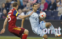 Sporting Kansas City midfielder Graham Zusi, right, plays the ball while covered by Real Salt Lake defender Rich Balchan (25) during the first half of an MLS soccer match in Kansas City, Kan., Saturday, April 5, 2014. (AP Photo/Orlin Wagner)