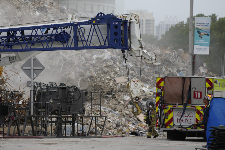 Crews work in the rubble of the demolished section of the Champlain Towers South building, as removal and recovery work continues at the site of the partially collapsed condo building, Monday, July 12, 2021, in Surfside, Fla.(AP Photo/Rebecca Blackwell)