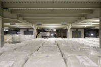 A worker drives past packed hospital beds, at the Linet factory in Slany, Czech Republic, Monday, Oct. 19, 2020. A Czech hospital bed maker with a full order book received one more order that was impossible to turn down. The company was approached by Prime Minister Andrej Babis to deliver beds for a military field hospital for 500 COVID-19 patients, to be built this week in Prague. (AP Photo/Petr David Josek)