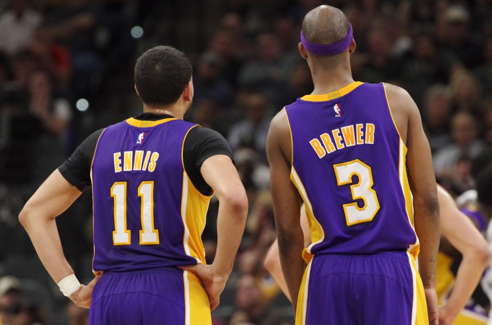 Tyler Ennis and Corey Brewer are getting plenty of playing time in place of the Lakers’ touted young talent. (AP)