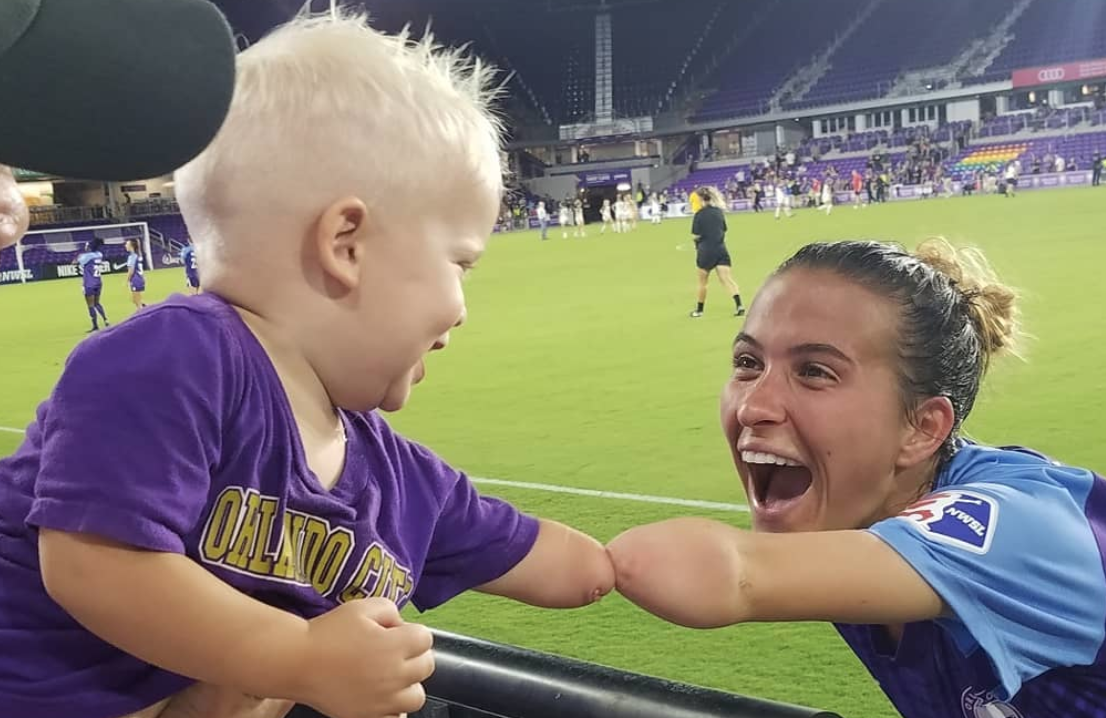 Orlando Pride's Carson Pickett meets a fan, Joseph Tidd, after a June 1 game against North Carolina Courage. Both Pickett and Tidd were born without their left forearm. (Photo: Instagram)