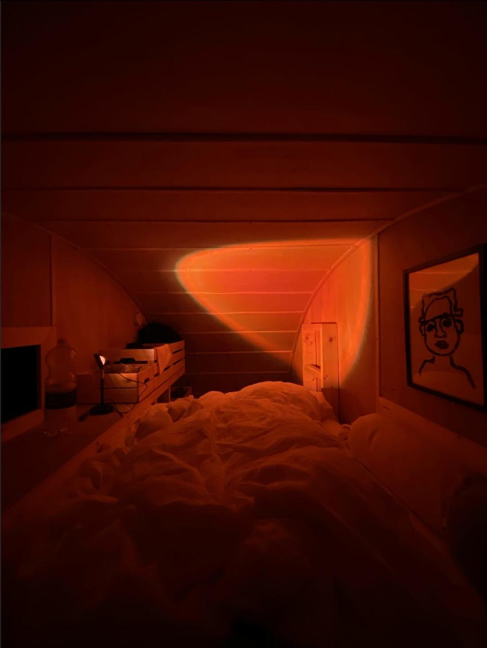 A view from the mezzanine bed at night with a red battery powered light
