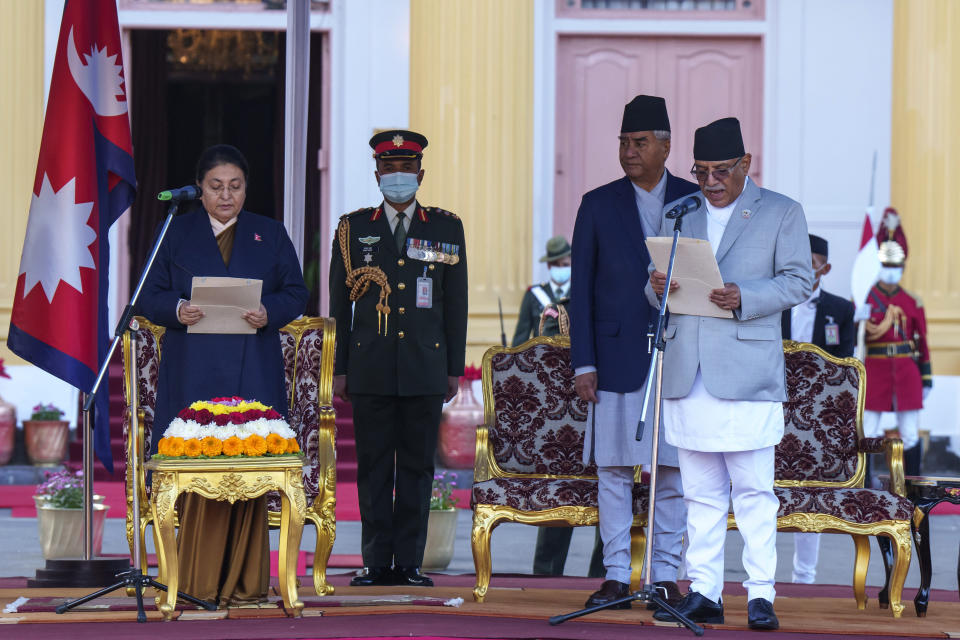 Nepal’s newly appointed prime minister Pushpa Kamal Dahal, right, is being sworn in by President Bidhya Devi Bhandari, left, at the President House in in Kathmandu, Nepal, Monday, Dec. 26, 2022. Dahal has appointed three deputies and four other ministers in the Cabinet that is expected to be expanded in the next few days to accommodate more members from the seven parties in the new coalition government. (AP Photo/Niranjan Shrestha)