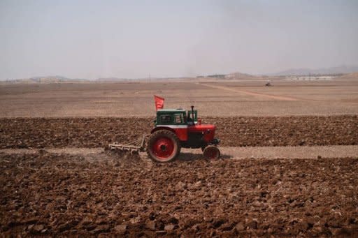 A tractor is seen from the window of a train along the railway line between Pyongyang and the North Phyongan Province on the west coast. North Korea is hardly known for offering a warm welcome to the world's press, and never before has it given access to a sensitive site featuring its latest space hardware