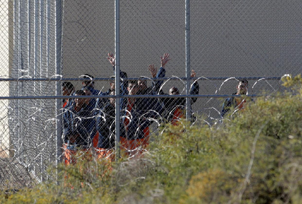 Migrants housed at the Otero County Processing Center walk through the yard in a 2020 file photo.