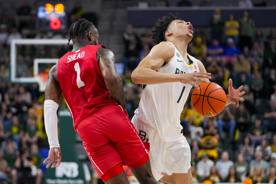 Baylor guard Miro Little, right, is fouled by Houston guard Jamal Shead during the first half of an NCAA college basketball game, Saturday, Feb. 24, 2024 in Waco, Texas. (AP Photo/Julio Cortez)