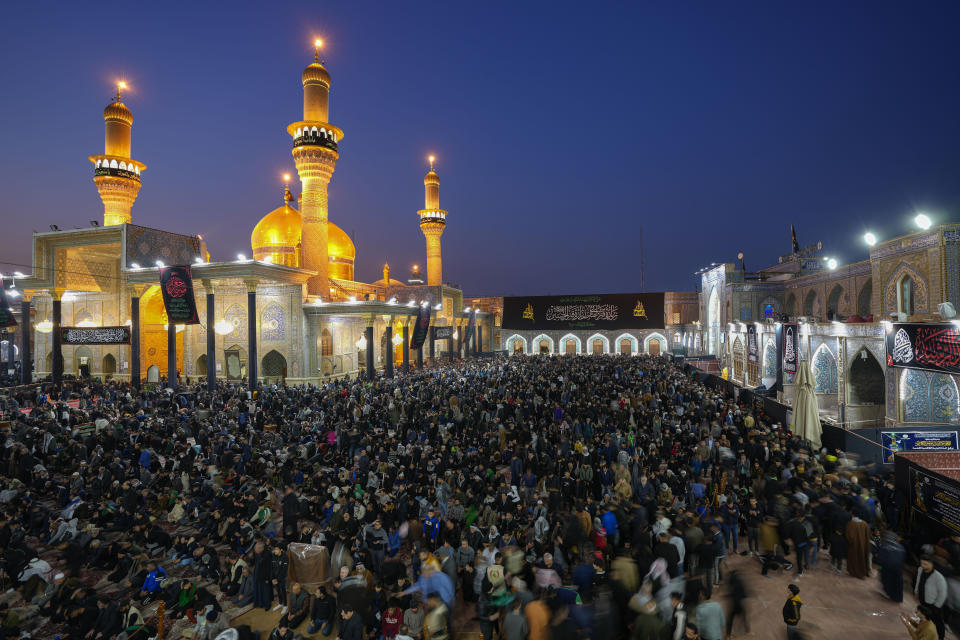 Shiite worshippers gather at the golden-domed shrine of Imam Moussa al-Kadhim, who died at the end of the eighth century, during the annual commemoration of the saint's death, in Baghdad, Iraq, Wednesday, Feb. 15, 2023. (AP Photo/Hadi Mizban)