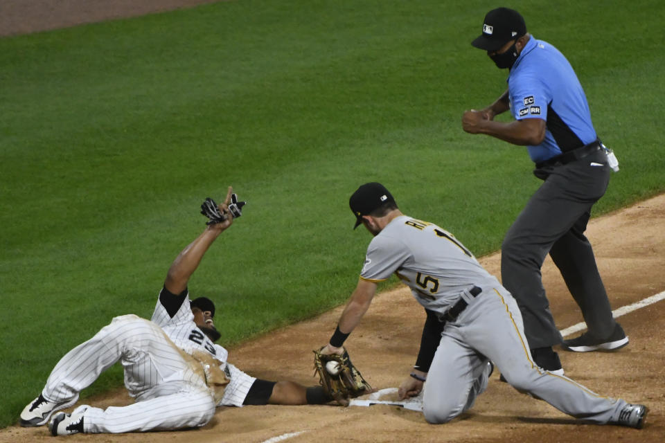 Chicago White Sox's Edwin Encarnacion, left, is tagged out at third base by Pittsburgh Pirates shortstop JT Riddle, right, during the third inning of a baseball game, Tuesday, Aug. 25, 2020, in Chicago. (AP Photo/Matt Marton)