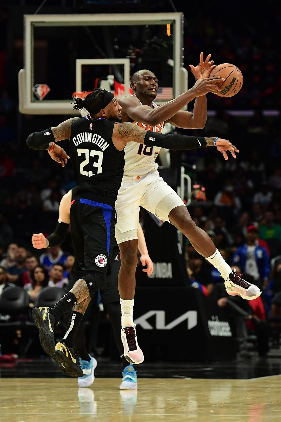 Apr 6, 2022; Los Angeles, California, USA; Phoenix Suns center Bismack Biyombo (18) gets the ball against Los Angeles Clippers forward Robert Covington (23) during the second half at Crypto.com Arena.