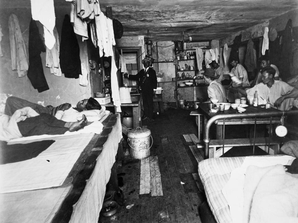People gather in the sleeping quarters in a tenement in New York City in 1905.