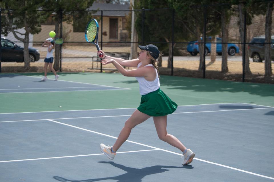 Pueblo County's Keelyn Tucker stretches out for a return shot during a doubles match at Pueblo City Park on April 14, 2023.