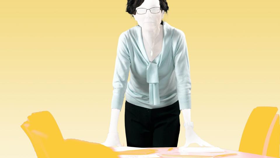 woman standing behind desk