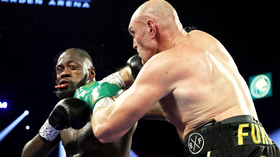 Deontay Wilder (pictured left) getting punched by Tyson Fury (pictured right).