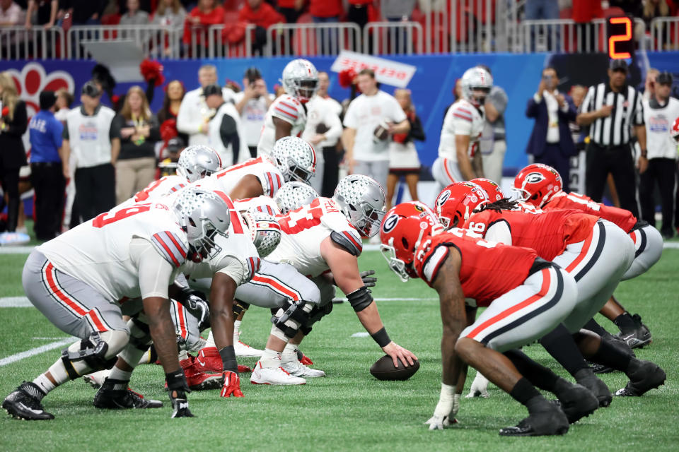 ATLANTA, GA - DECEMBER 31:  Teams line up for a play during the college football Playoff Semifinal game at the Chick-fil-a Peach Bowl between the Georgia Bulldogs and the Ohio State Buckeyes on December 31, 2022 at Mercedes-Benz Stadium in Atlanta, Georgia.  (Photo by Michael Wade/Icon Sportswire via Getty Images)
