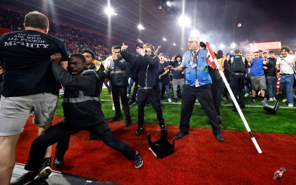 Police and ground staff attempt to separate the Southampton fans from the West Bromwich Albion away stand