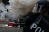 A firefighter extinguishes a limousine which was set ablaze during a protest against U.S. President Donald Trump on the sidelines of the inauguration in Washington, D.C., U.S., on January 20, 2017. REUTERS/Adrees Latif