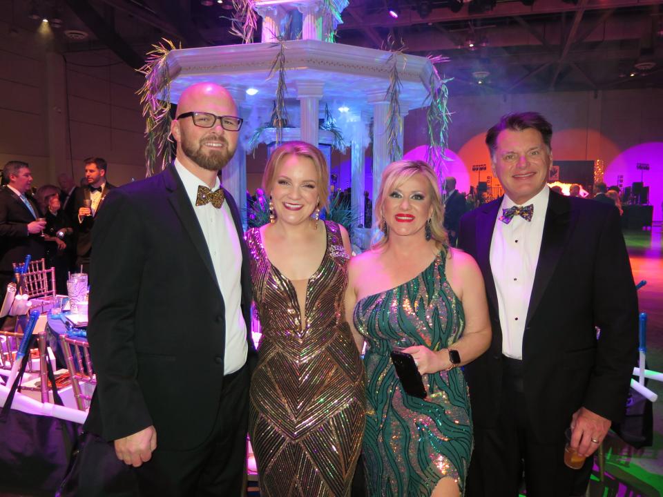 Aaron and Britney Beumeler, and Jamie and John Reeves in front of the king's table at Gemini Grande Bal.