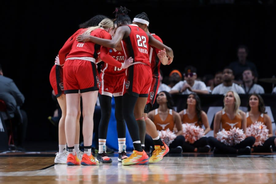 North Carolina State players huddle during the first half of an Elite Eight college basketball game against Texas in the women’s NCAA Tournament, Sunday, March 31, 2024, in Portland, Ore. (AP Photo/Howard Lao)
