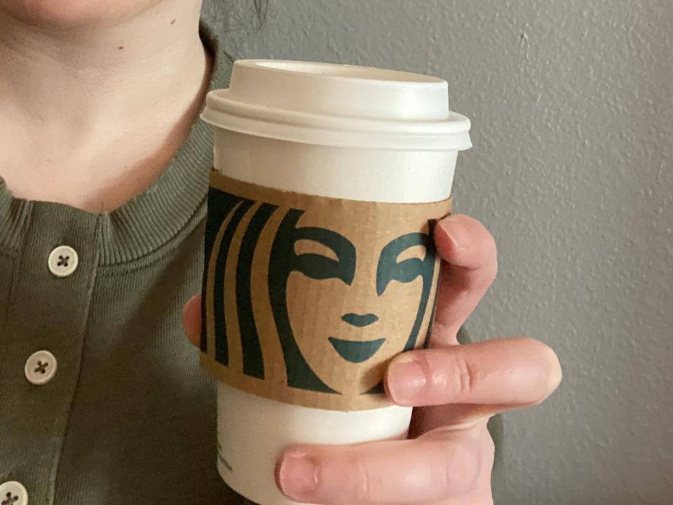 paige bennett holding chai latte from starbucks