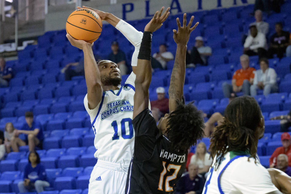 Texas A&M Corpus Christi forward Isaac Mushila (10) shoots against Northwestern State guard Jalen Hampton (12) during the first half an NCAA college basketball game in the finals of the Southland Conference men's tournament in Lake Charles, La., Wednesday, March 8, 2023. (AP Photo/Matthew Hinton)