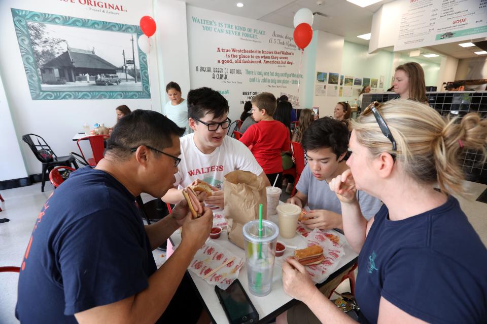 Walter's fans Patrick Liu, left, Harry Liu, 17, Hayden Claussen, 14, and Kendra Claussen of White Plains enjoy lunch at the new Walter's Hot Dogs in White Plains on opening day Aug. 26, 2018. 