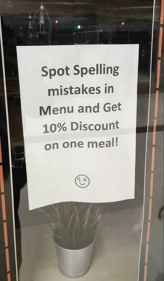 Sign on the glass door offering 10% off to spot spelling mistakes in the menu