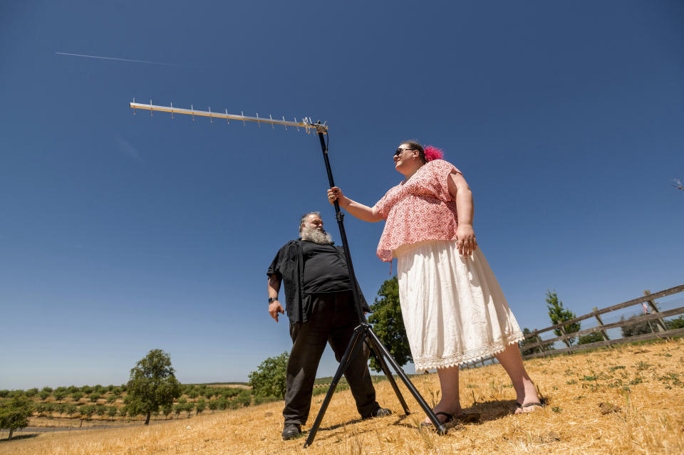 Hackers Kristin Paget, right, and Marc Rogers adjust an antenna while testing radio frequency identification signal range in Hickman, Calif., on Sunday, June 6, 2021. Paget first warned publicly about the vulnerabilities of RFID in 2010, during a presentation at the annual DEF CON hacker convention. (AP Photo/Noah Berger)