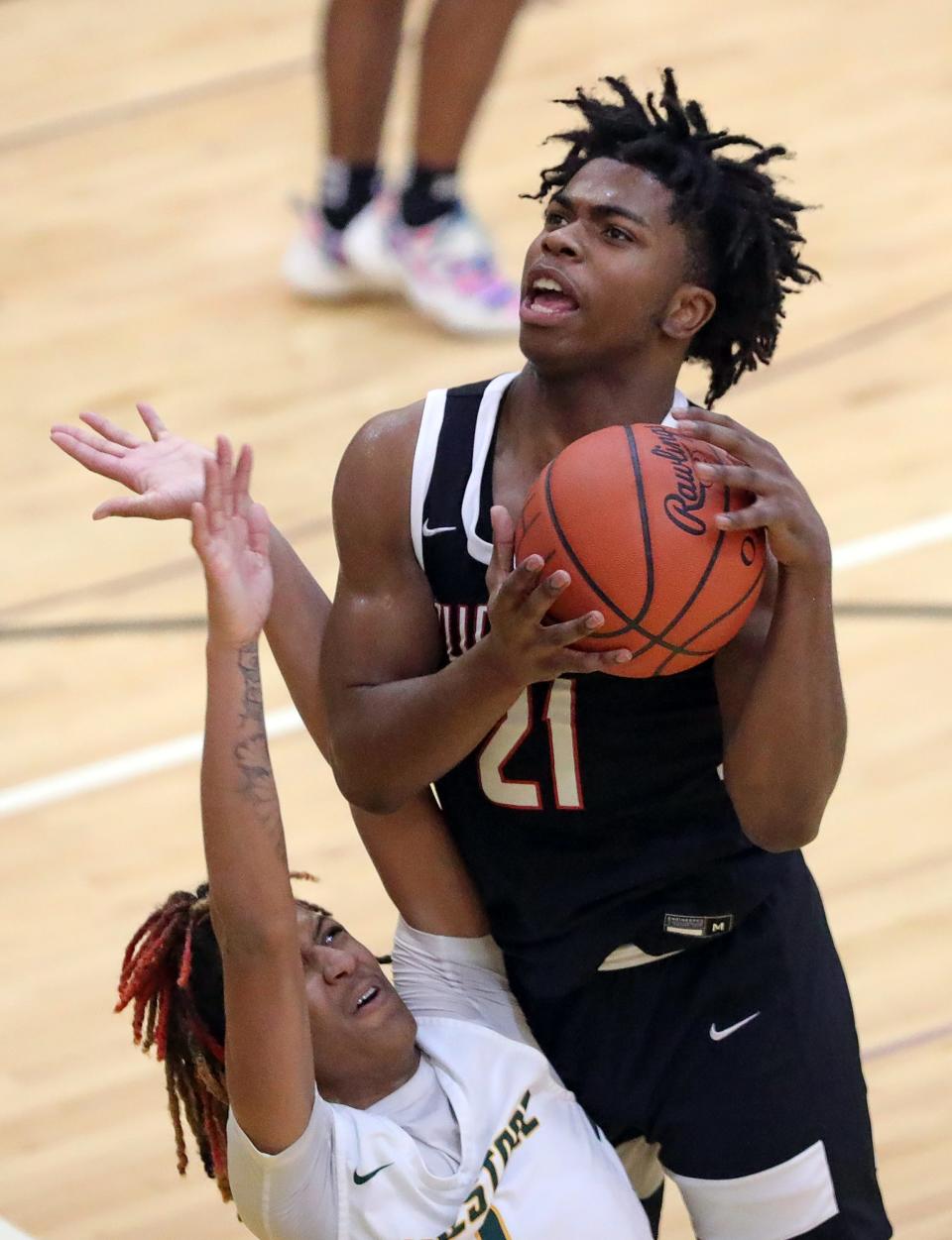 Buchtel's Khoi Thurmon, top, is fouled while shooting by Firestone's Amir Hubbard during the second half of a basketball game, Friday, Dec. 9, 2022, in Akron, Ohio.