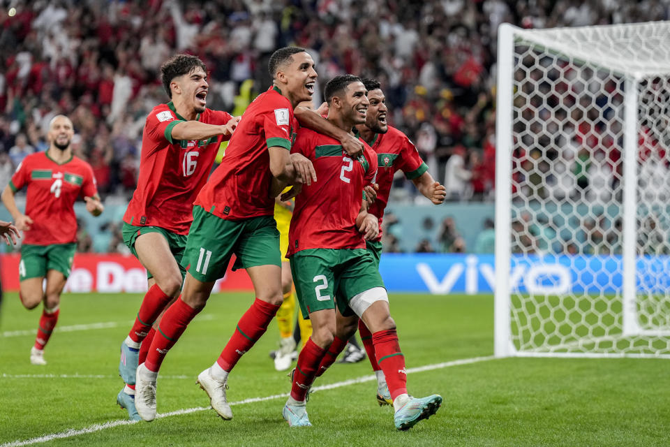 Morocco's players celebrate their victory over Spain during the World Cup round of 16 soccer match between Morocco and Spain, at the Education City Stadium in Al Rayyan, Qatar, Tuesday, Dec. 6, 2022. (AP Photo/Martin Meissner)