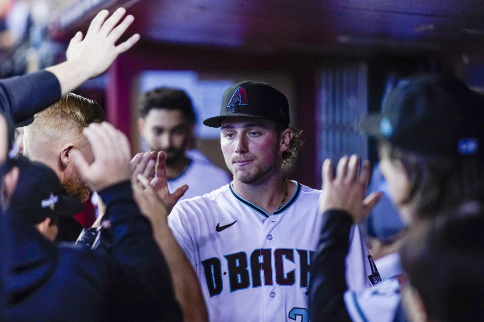 Arizona Diamondbacks starting pitcher Brandon Pfaadt is greeted in the dugout after leaving the game against the Philadelphia Phillies during the sixth inning in Game 3 of the baseball NL Championship Series in Phoenix, Thursday, Oct. 19, 2023. (AP Photo/Ross D. Franklin)